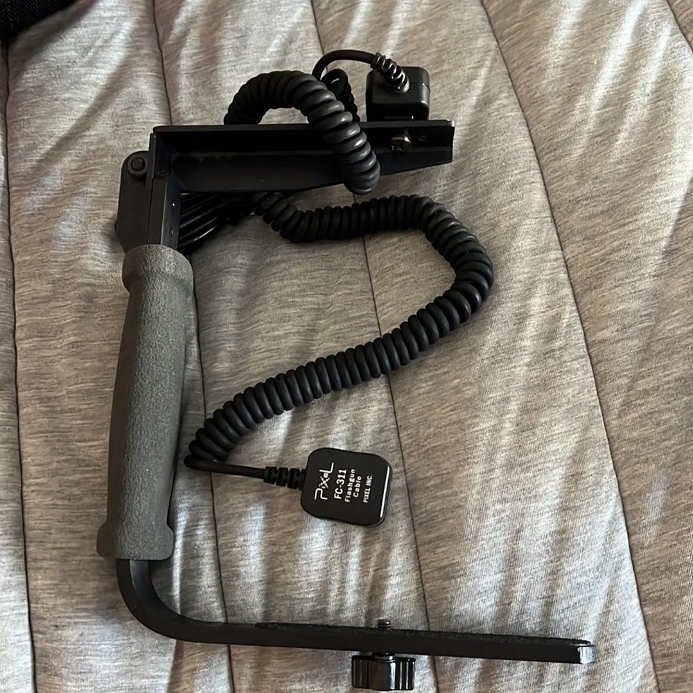 Canon batter pack with case and camera frame with flashgun cable